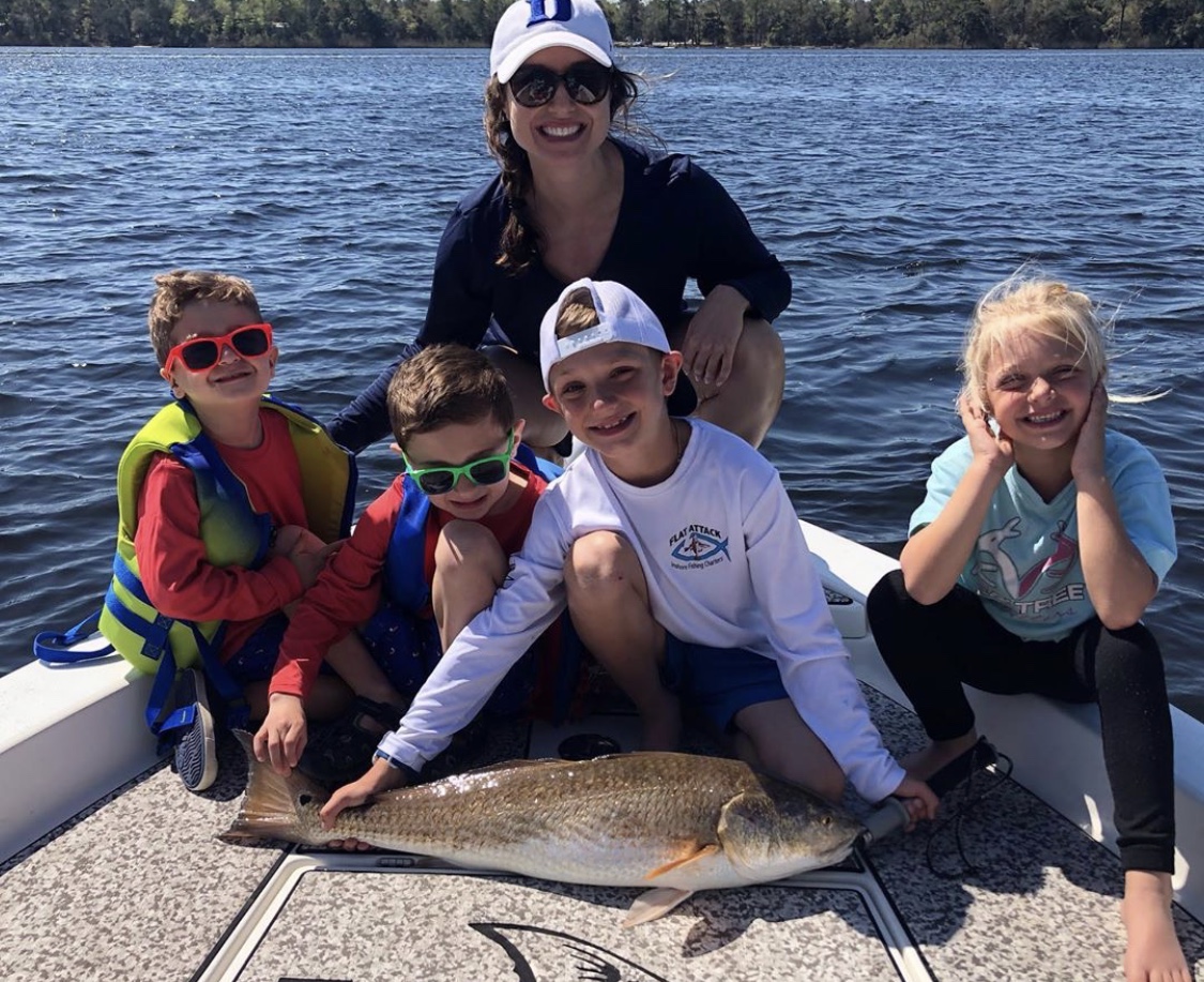 Mother and family with large fish